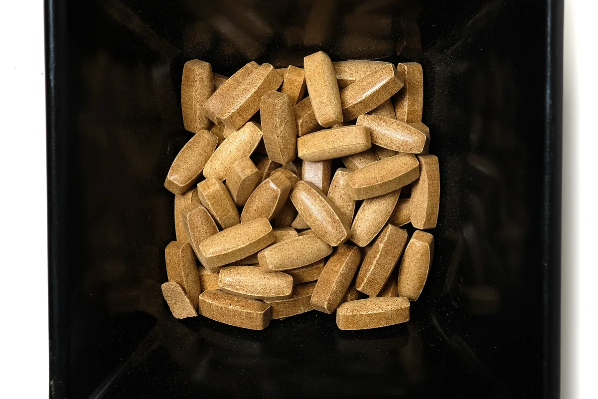 Left Coast Kratom Platinum chewable tea tablets in a black dish